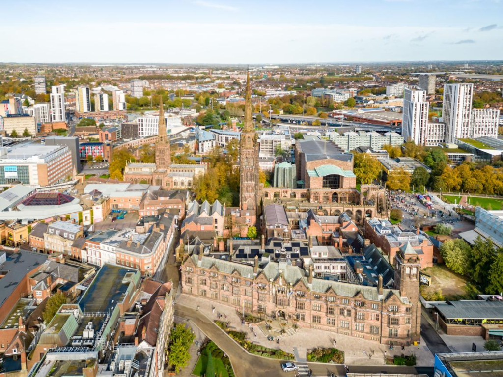 An aerial view of Coventry showing the city skyline and Coventry Cathedral.
