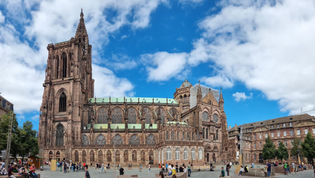 Tourists visiting Strasbourg Cathedral with historic architecture and surrounding streets.