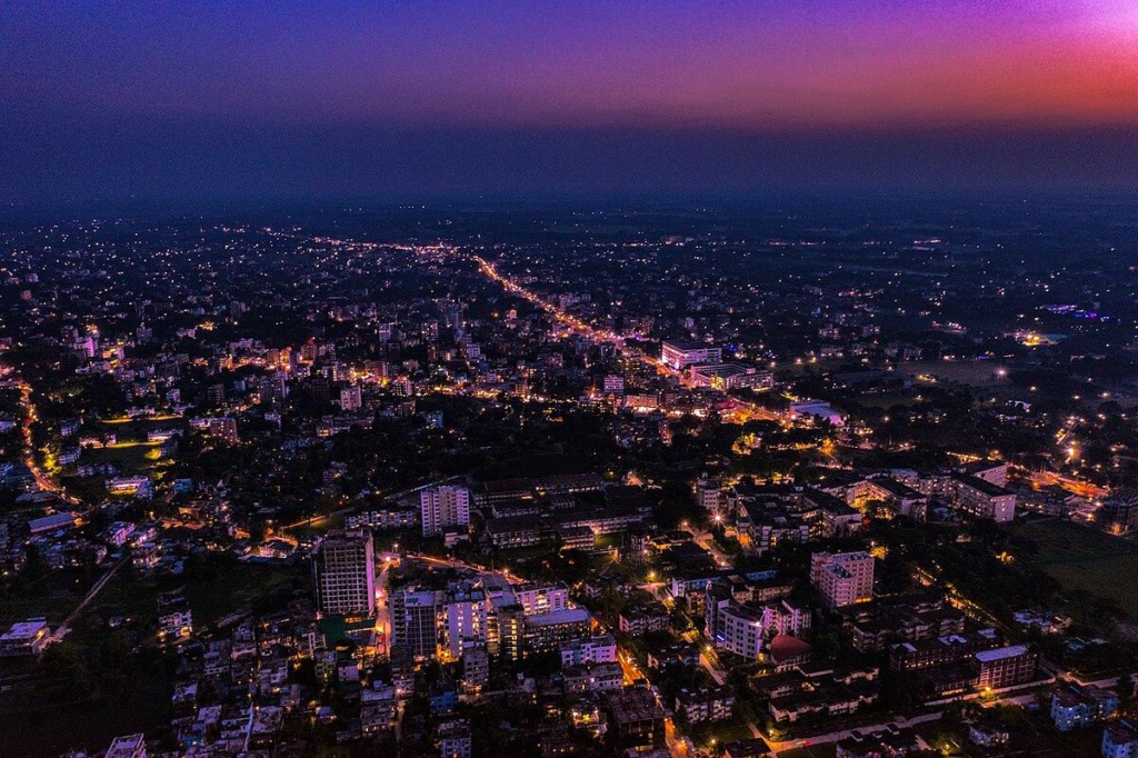 A panoramic aerial view of Rangpur showing the cityscape, rivers, and surrounding green landscapes in Bangladesh.