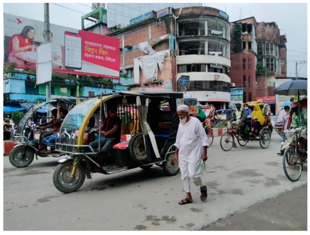 Visitors walking through streets in Rangpur with local markets, shops, and pedestrian activity.