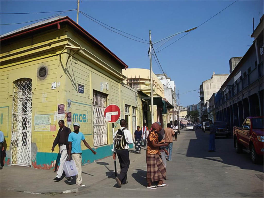 Visitors walking through streets in Beira with local shops, markets, and pedestrian activity.