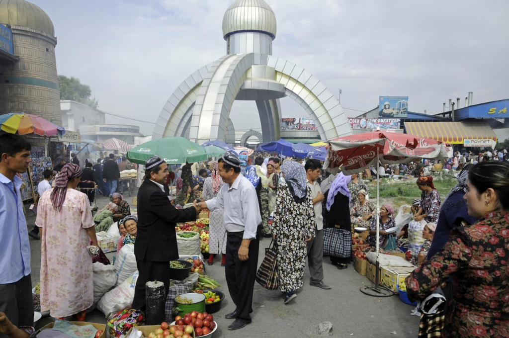 Visitors walking through streets in Kokand with local markets, shops, and pedestrian activity