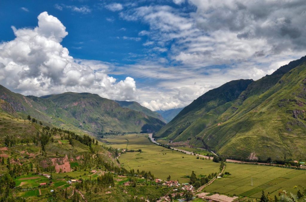 Green agricultural terraces and mountains in Peru's Sacred Valley.